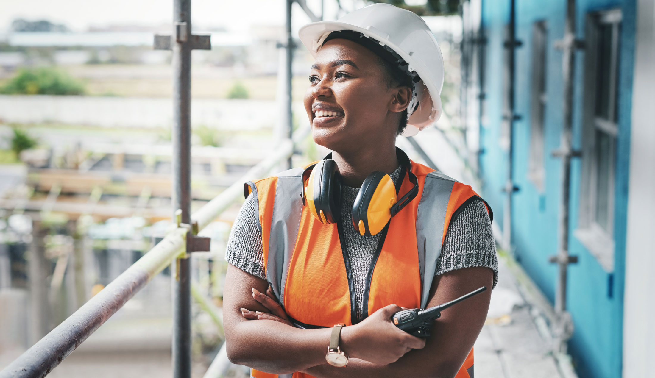 Smiling female construction worker wearing a hard hat