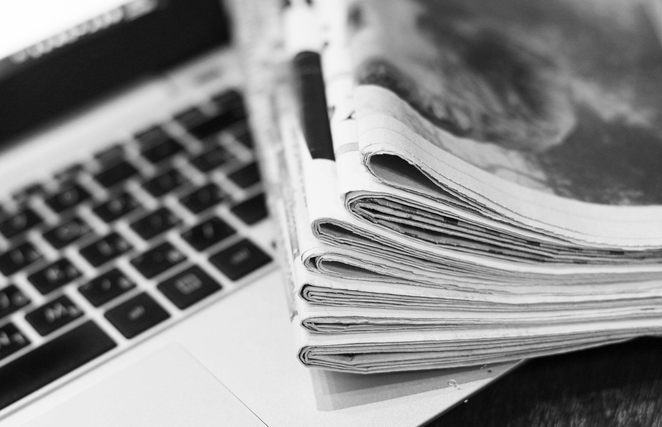 A stack of newspapers lying on a computer