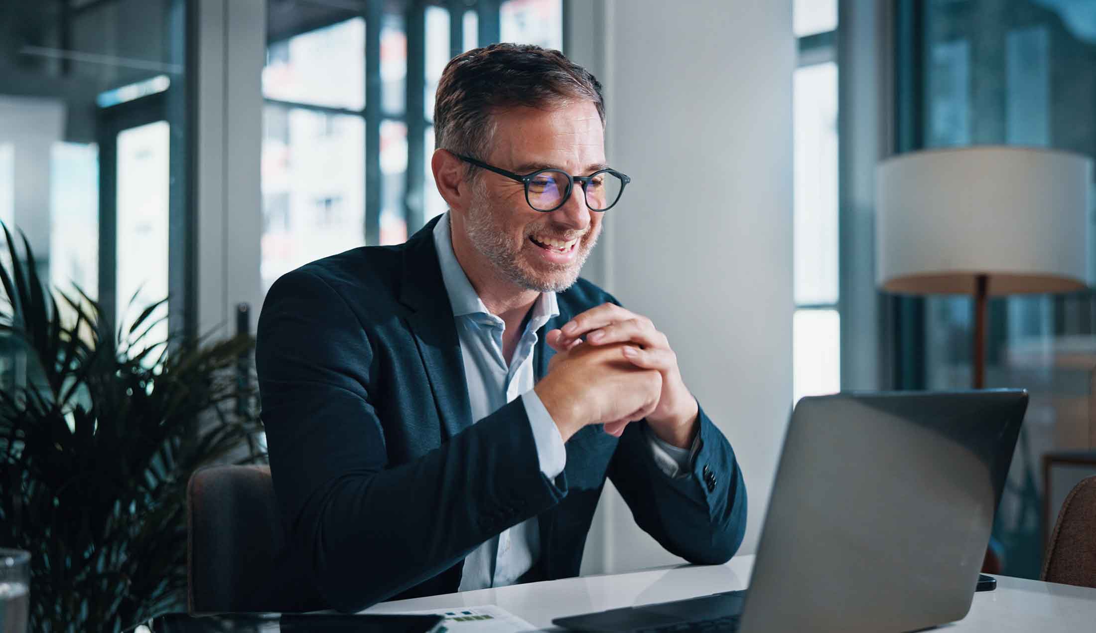 The photo is taken from above. Two men can be seen walking inside a raw industrial building.