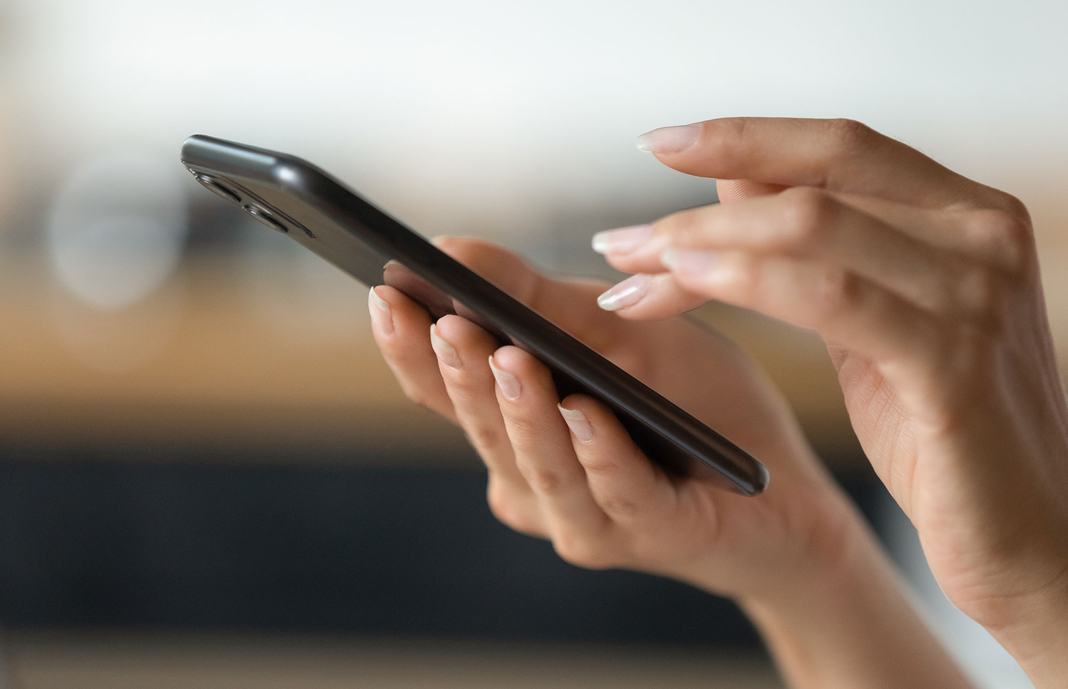 Woman's hands holding a mobile phone.